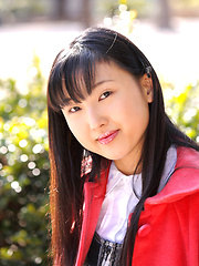 Japanese tramp poses in her school uniform as she waits