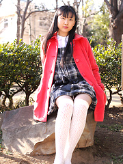 Japanese tramp poses in her school uniform as she waits