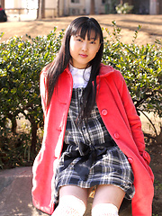 Japanese tramp poses in her school uniform as she waits