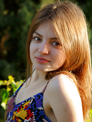 Klarissa shows off her bushy pussy as she poses outdoors.