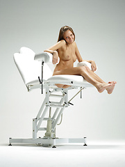Cute blonde babe posing on ginecologic chair