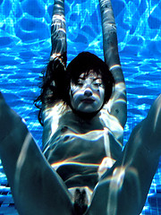 Water girl looks dazzling with sparkling water dripping off her naked sexy body.